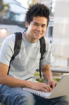 Royalty Free Photo of a Young Man With a Laptop