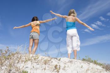 Royalty Free Photo of Two Girls on a Sand Dune