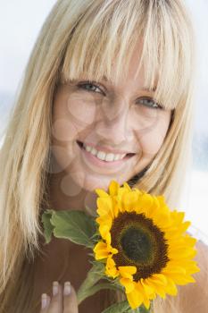 Royalty Free Photo of a Woman Holding a Sunflower