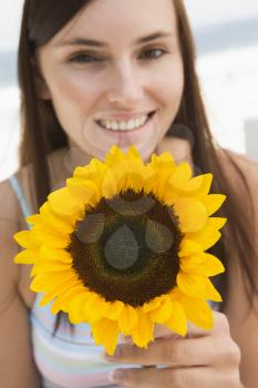 Royalty Free Photo of a Girl Holding a Sunflower