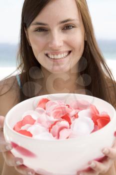 Royalty Free Photo of a Woman With a Bowl of Rose Petals
