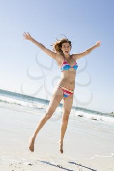 Royalty Free Photo of a Girl Jumping at the Beach