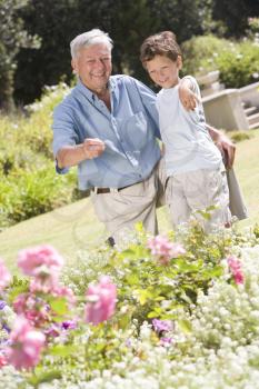 Royalty Free Photo of a Grandfather and Grandson in a Garden