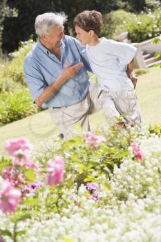 Royalty Free Photo of a Grandfather and Grandson in the Garden