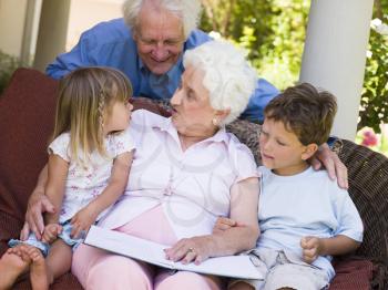 Royalty Free Photo of Grandparents Reading to Grandchildren