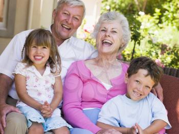 Royalty Free Photo of Grandparents Laughing With Grandchildren