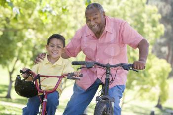 Royalty Free Photo of a Man and His Grandson on Bikes