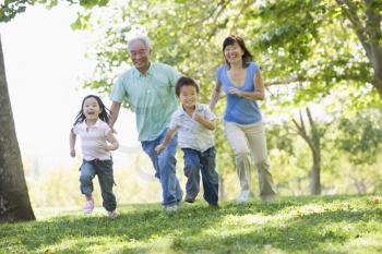 Royalty Free Photo of Grandparents Running With Their Grandchildren