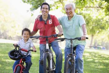 Royalty Free Photo of Three Generations of Males Out Biking