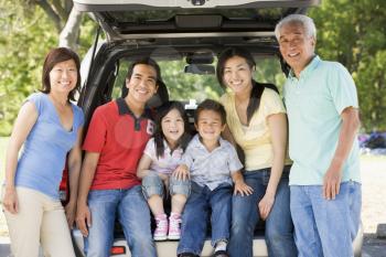Royalty Free Photo of a Family at a Hatchback