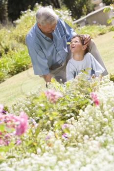 Royalty Free Photo of a Man and His Grandson in a Garden