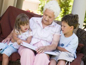 Royalty Free Photo of a Woman Reading to Her Grandchildren