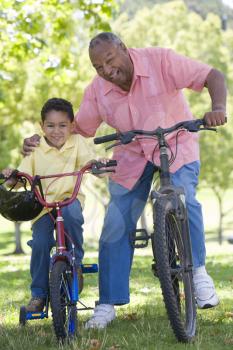 Royalty Free Photo of a Man and Boy on Bikes
