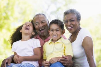 Royalty Free Photo of a Couple Laughing With Their Grandchildren