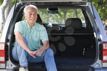 Royalty Free Photo of a Man in the Back of a Hatchback