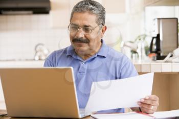 Royalty Free Photo of a Man Doing Paperwork at Home