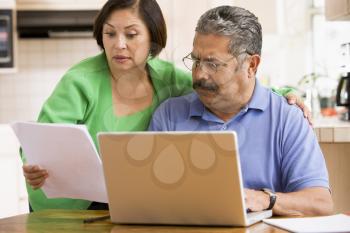 Royalty Free Photo of a Couple Looking Worried at a Laptop