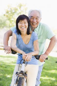 Royalty Free Photo of a Couple Riding a Bike