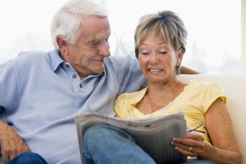 Royalty Free Photo of a Couple Reading the Paper