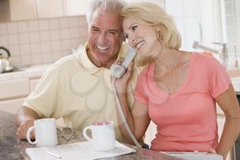 Royalty Free Photo of a Couple on the Phone While Drinking Coffee