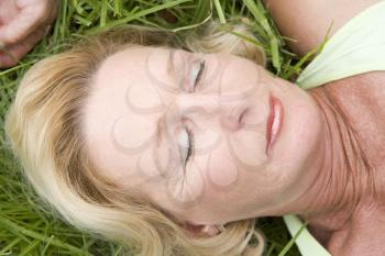 Royalty Free Photo of a Woman Asleep on the Grass