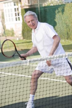 Royalty Free Photo of a Man Playing Tennis