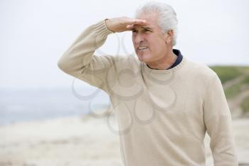 Royalty Free Photo of a Man Looking For Something at the Beach