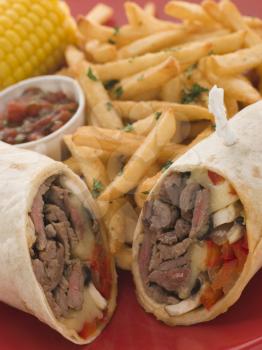 Royalty Free Photo of Philly Beef Steak Wrap with Fries Tomato, Salsa and Corn