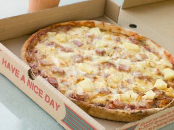 Royalty Free Photo of a Ham and Pineapple Pizza