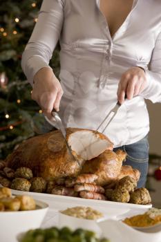 Royalty Free Photo of a Woman Carving Turkey