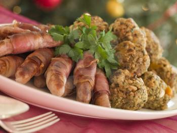 Royalty Free Photo of a Plate of Pigs in Blankets and Chestnut Stuffing Balls