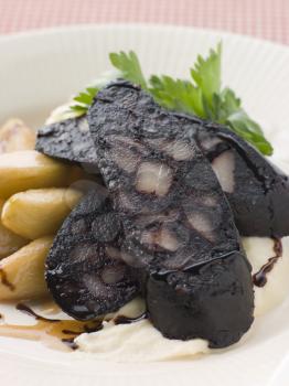 Royalty Free Photo of Boudin Noir Caramelised Apples and Pomme Puree with Balsamic