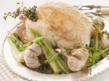 Royalty Free Photo of a 40 Clove of Garlic Roasted Chicken with Baby Spring Vegetables