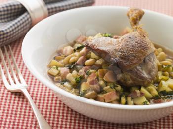 Royalty Free Photo of Confit Duck Leg with Flageolet Beans and Bacon