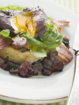 Royalty Free Photo of Red Wine Poached Egg With Bacon and Toasted Brioche