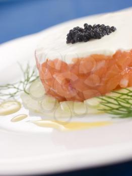 Royalty Free Photo of a Tartare of Wild Salmon Creme Fraiche Cucumber Caviar and Lemon Oil