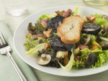 Royalty Free Photo of a Salad Maison - Boudin Noir Bacon and Mushrooms