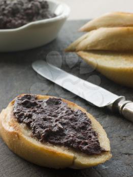 Royalty Free Photo of Black Olive Tapenade With Toasted Baguette