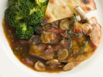 Royalty Free Photo of Sauteed Chicken Chasseur With Broccoli and Pomme Anna