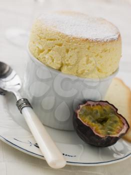 Royalty Free Photo of Hot Passion Fruit Souffle with Langue de Chat Biscuits
