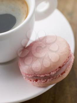 Royalty Free Photo of a Raspberry Macaroon with a Cup of Espresso