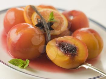 Royalty Free Photo of a Bowl of Peaches Poached in Sauternes Wine