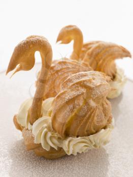 Royalty Free Photo of Two Choux Swans filled with Chantilly Cream