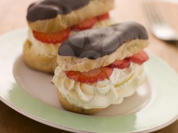 Royalty Free Photo of Chocolate and Strawberry Filled Eclairs