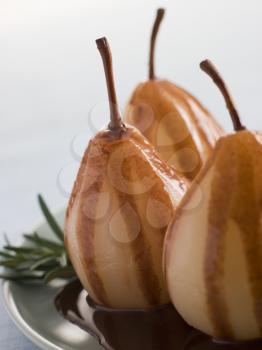 Royalty Free Photo of Pear Poached With Rosemary and a Chocolate sauce