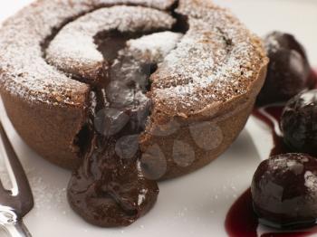 Royalty Free Photo of Hot Chocolate Fondant Pudding with Black Cherry Syrup