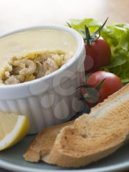 Royalty Free Photo of Potted Brown Shrimp with Toast and Salad