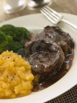 Royalty Free Photo of a Shin of Beef Braised in Stout with Mashed Swede and Broccoli