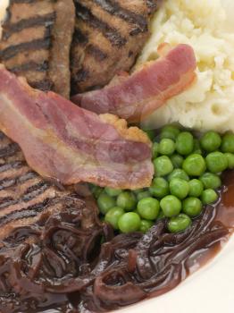 Royalty Free Photo of Grilled Calves Liver and Bacon with Mashed Potato and Peas