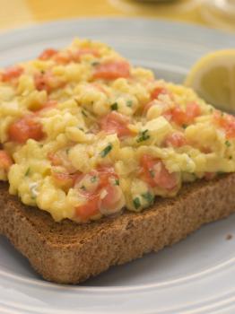 Royalty Free Photo of Scrambled Egg and Smoked Salmon on Brown Toast